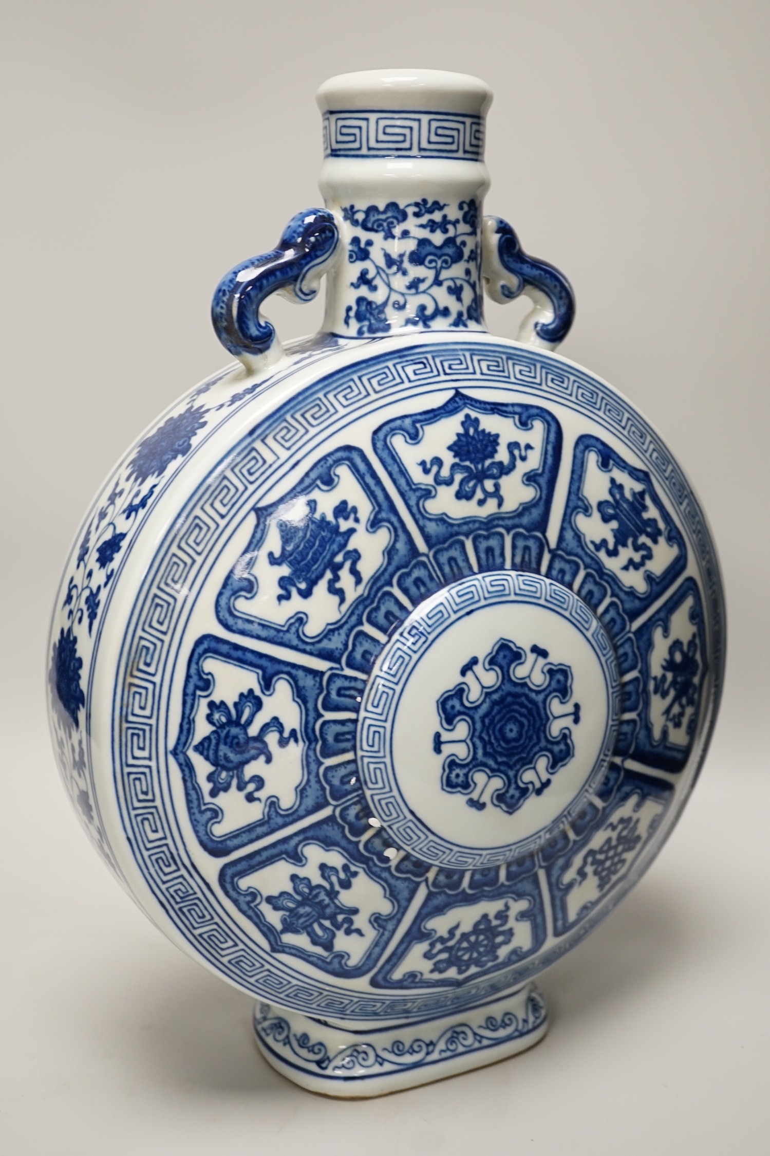 A Chinese blue and white two handled moonflask, together with another Chinese vase and Chinese figure group, tallest 36cm